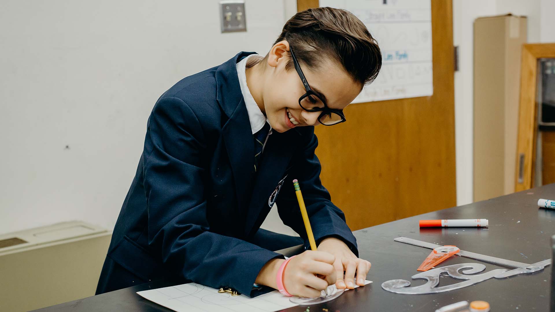 SofO student writing on paper